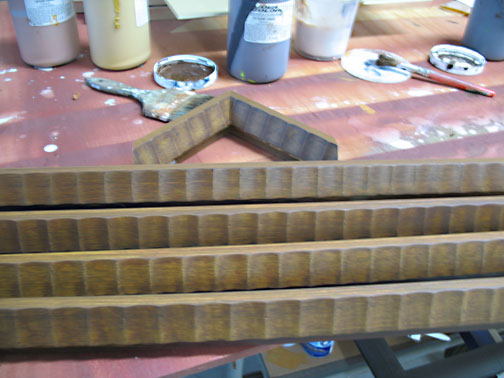 painted faux wood grain finish on commercial picture frame moulding